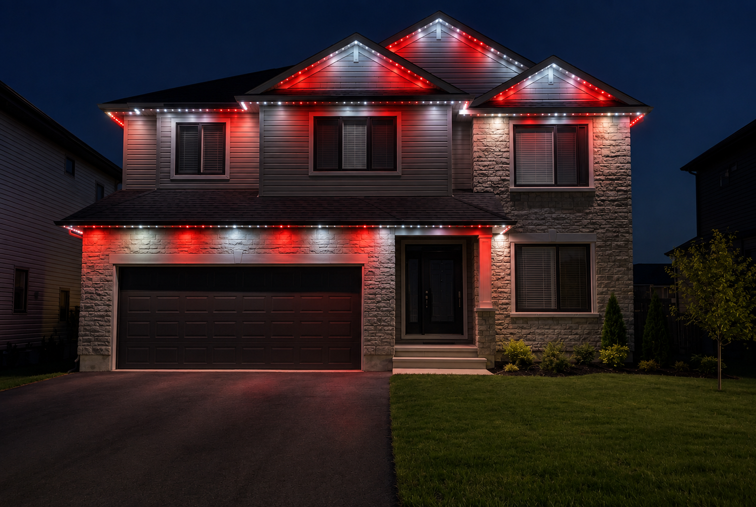 Ottawa two-story home with permanent red and white track lighting along the rooflines and eaves